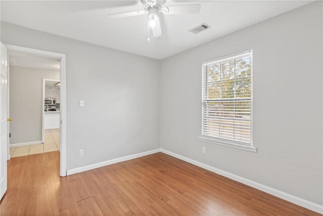 unfurnished room featuring ceiling fan and light hardwood / wood-style floors