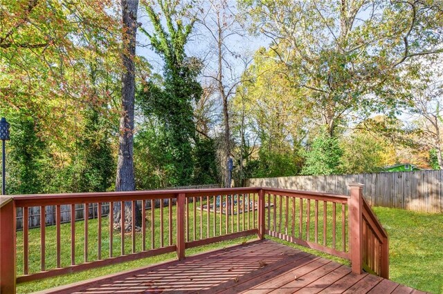 wooden deck with a lawn