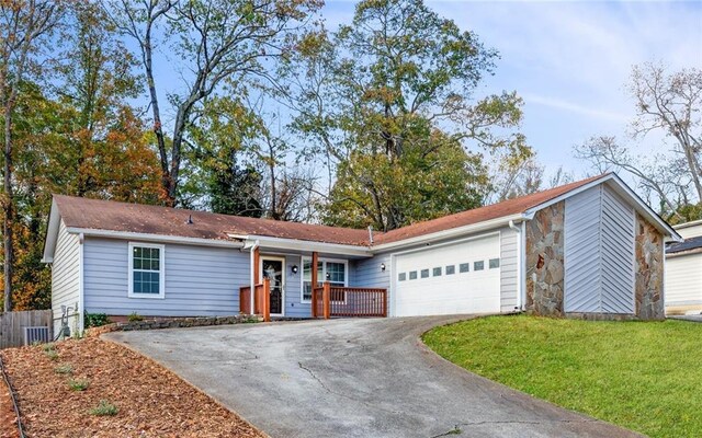 ranch-style home with covered porch, a front yard, and a garage