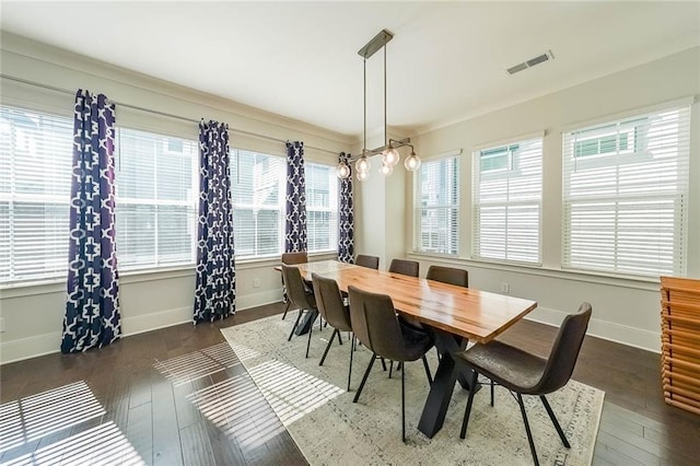 dining space featuring dark wood-style flooring, visible vents, and a healthy amount of sunlight