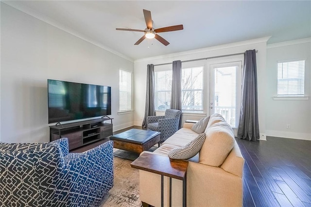 living room featuring ornamental molding, ceiling fan, baseboards, and wood finished floors