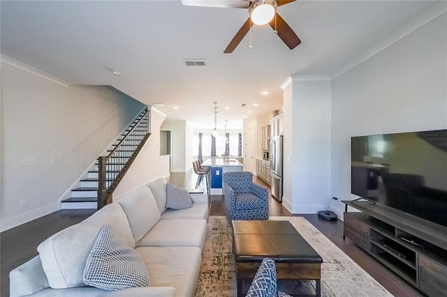 living room featuring visible vents, stairs, ornamental molding, and baseboards