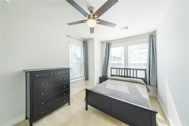 bedroom with light carpet, baseboards, and visible vents