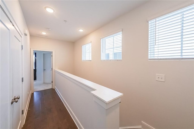 hall with recessed lighting, dark wood finished floors, and baseboards