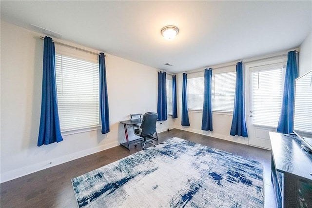 office featuring wood finished floors, visible vents, and baseboards