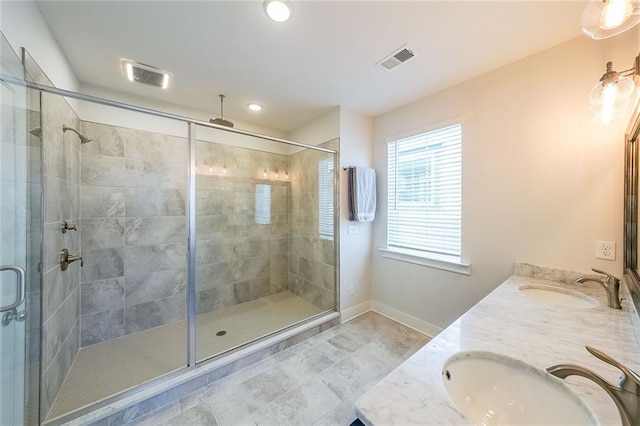 full bath featuring a stall shower, visible vents, and a sink