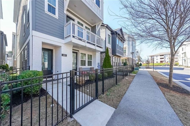 exterior space with a fenced front yard and a residential view