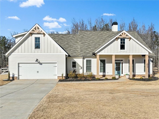 view of front of house with a garage, a front yard, and a porch