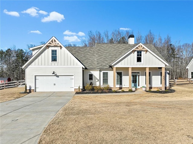 view of front of home with a garage, a front lawn, and a porch