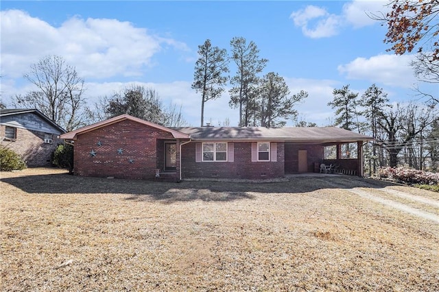 ranch-style house with a carport and a front lawn