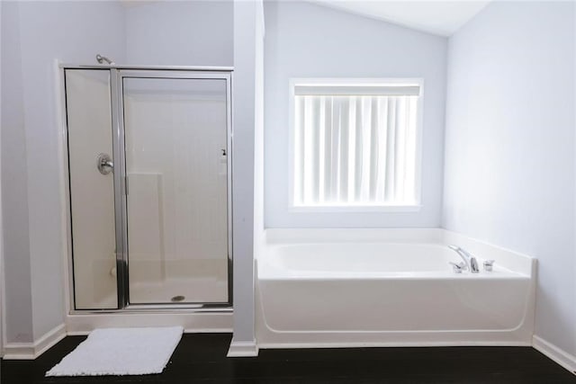 bathroom with shower with separate bathtub and lofted ceiling