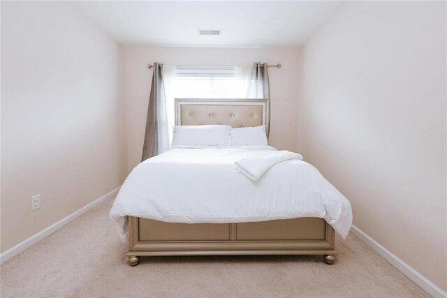 bedroom with light colored carpet