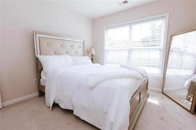 bedroom featuring light colored carpet