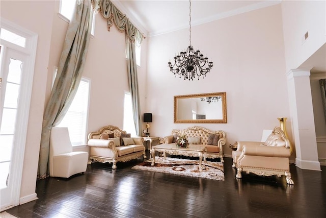 sitting room featuring a notable chandelier, dark hardwood / wood-style floors, plenty of natural light, and a towering ceiling