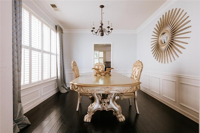 dining room with ornamental molding, dark wood-type flooring, a wealth of natural light, and a chandelier