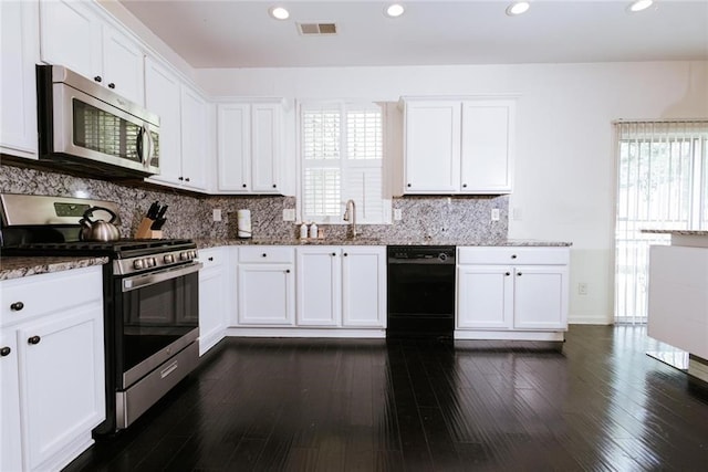 kitchen featuring white cabinets, appliances with stainless steel finishes, and light stone countertops