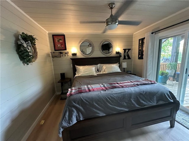 bedroom with hardwood / wood-style floors, access to outside, and ceiling fan