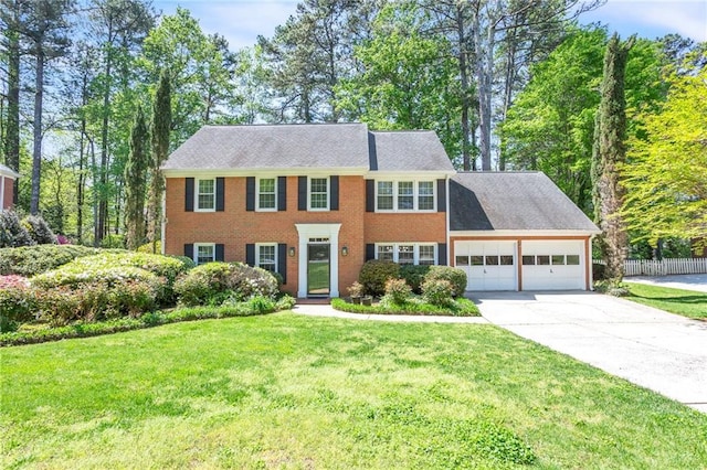colonial house with an attached garage and driveway
