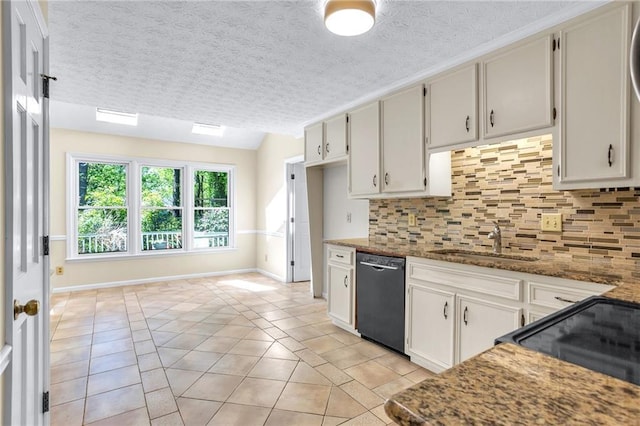 kitchen featuring black appliances, a sink, backsplash, light tile patterned floors, and baseboards