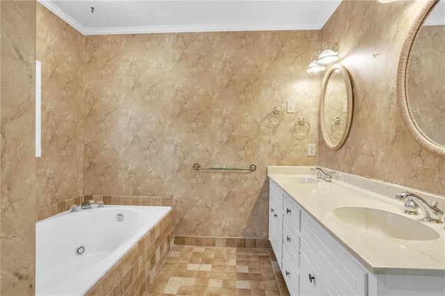 bathroom with tiled bath, ornamental molding, double vanity, and baseboards
