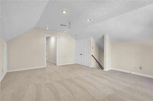 bonus room featuring a textured ceiling, carpet floors, lofted ceiling, baseboards, and recessed lighting