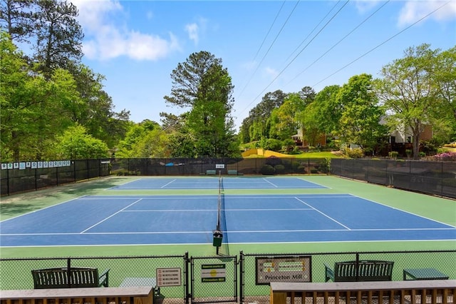 view of tennis court featuring community basketball court and a gate