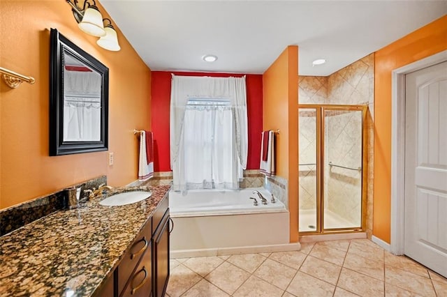 bathroom featuring shower with separate bathtub, tile patterned floors, and vanity