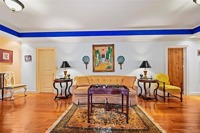 sitting room featuring ornamental molding and hardwood / wood-style floors