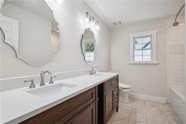 bathroom with double vanity, toilet, a sink, and marble finish floor