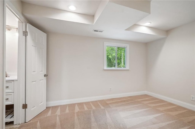 interior space featuring baseboards, light carpet, recessed lighting, and visible vents