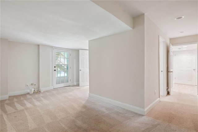carpeted empty room featuring baseboards