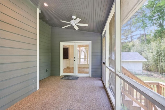unfurnished sunroom featuring ceiling fan and french doors