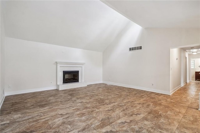 unfurnished living room featuring visible vents, a fireplace with raised hearth, baseboards, and lofted ceiling