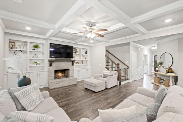 living room with beamed ceiling, crown molding, coffered ceiling, dark hardwood / wood-style flooring, and a fireplace