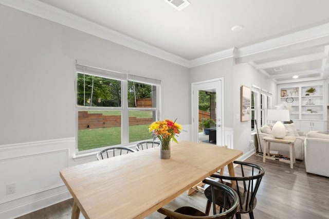 dining room with built in shelves, hardwood / wood-style flooring, crown molding, and beam ceiling