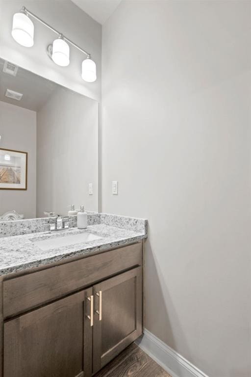 bathroom with hardwood / wood-style flooring and vanity