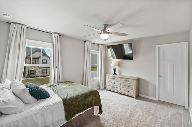 bedroom with ceiling fan and light carpet