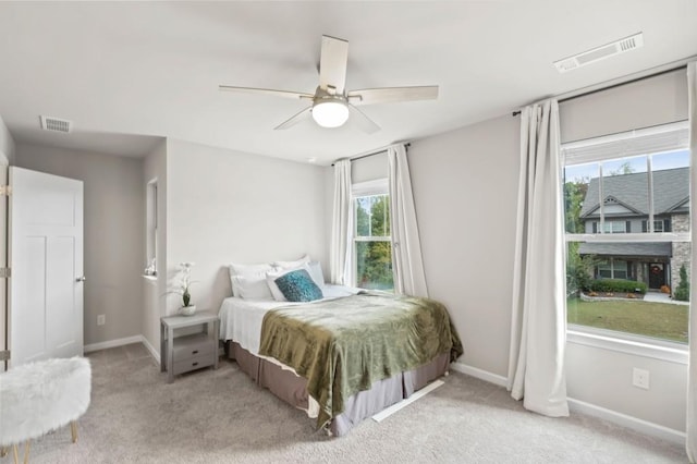 bedroom with ceiling fan and light carpet