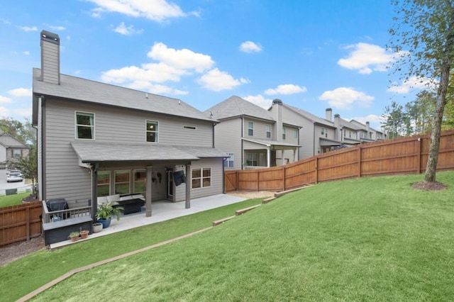 rear view of house with outdoor lounge area, a yard, and a patio area