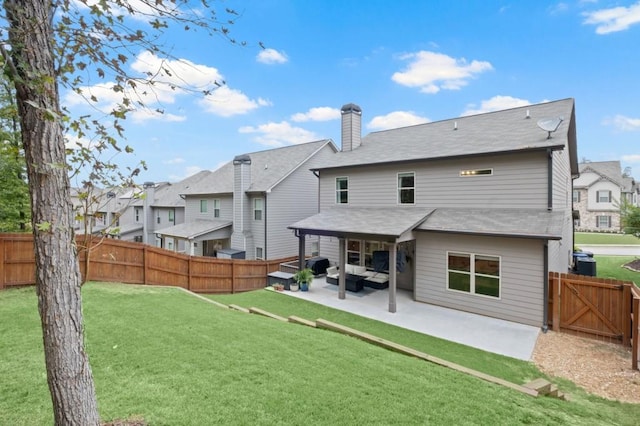 back of property featuring a yard, central AC, and a patio