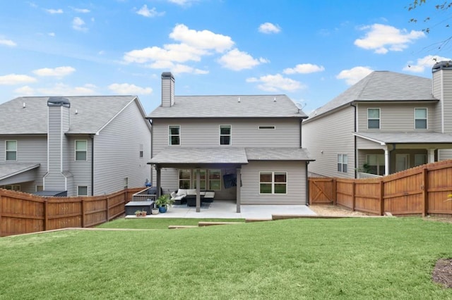 rear view of house with a yard and a patio