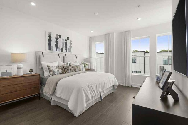 bedroom with dark hardwood / wood-style flooring