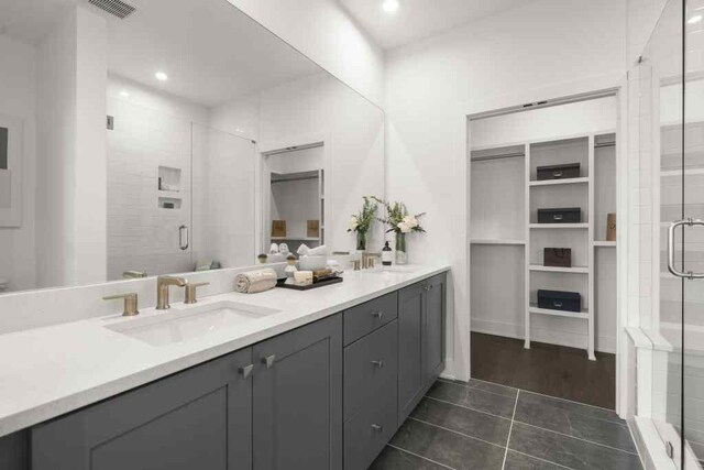 bathroom with a shower with door, vanity, and wood-type flooring