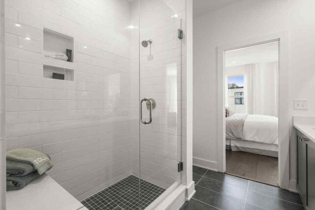 bathroom with wood-type flooring, an enclosed shower, and vanity