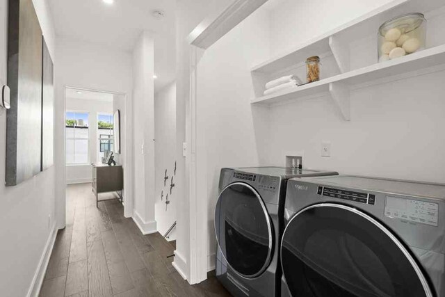 laundry area with dark hardwood / wood-style floors and independent washer and dryer