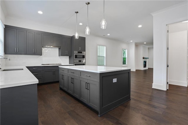 kitchen featuring a sink, gray cabinetry, light countertops, gas stovetop, and dark wood-style flooring