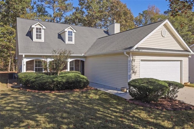 cape cod house with a front yard and a garage