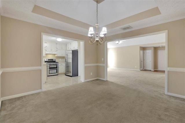 interior space featuring light carpet, crown molding, a tray ceiling, and a notable chandelier