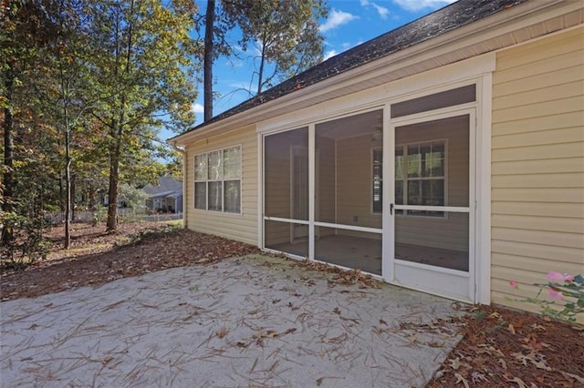 exterior space with a sunroom and a patio area