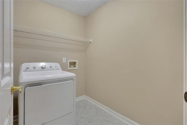 laundry area featuring washer / dryer and a textured ceiling